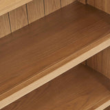 Wooden bookshelf with empty shelves, exhibiting a warm brown tone, positioned against a similar wood-paneled background.