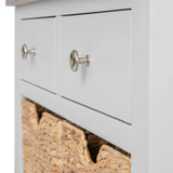 A white chest of drawers with metallic knobs, one drawer slightly open revealing a straw basket inside.