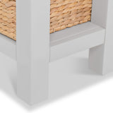 A wicker basket on a gray shelf, framed by a white vertical post, against a solid white background.