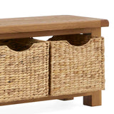 A wooden coffee table with two woven baskets underneath, on a plain white background. The baskets appear to be inserted into shelf-like spaces.