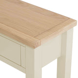 A light wood tabletop corner with a cream-colored leg and side, showcasing joinery details against a white background.