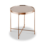 A round, copper-colored side table stands against a white background, featuring a reflective surface and slender intersecting legs.