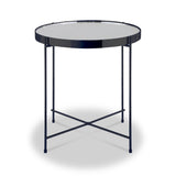 A round table with a reflective surface and dark rim, supported by a crossed metal frame, stands isolated on a light background.