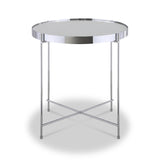 A round, silver-colored metal table stands center, featuring a reflective tabletop and crisscrossed legs, isolated against a white background.