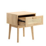 A wooden nightstand with one open drawer showing empty space inside; it has slender legs and a perforated panel design. No text present.