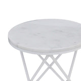 A round table with a marble top and white metal legs stands idle against a blank background.