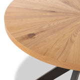 A round wooden tabletop with visible grain patterns, positioned on a black metal base, partially visible, set against a white background.