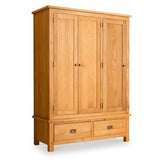 A wooden wardrobe stands against a white background, featuring two doors and a lower section with two drawers, all with round knobs.