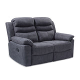 A plush, dark gray, two-seater recliner sofa with padded armrests, positioned on a plain, light background.