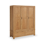 A wooden wardrobe with closed doors and drawers stands isolated against a white background.