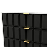 A black textured cabinet with gold handles, partially open, revealing a white interior.