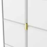 A golden-colored door handle on a white door, slightly ajar, with a gray horizontal stripe, set against a plain background.