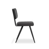 A modern black chair with a ribbed cushion on both the seat and backrest, stands isolated against a white background.