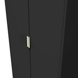 A sleek black wardrobe with a simple gold handle is partially open, revealing darkness within, against a black background.