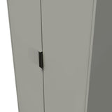 A minimalistic grey cabinet with a black vertical handle centered on its door, set against a plain, light background.