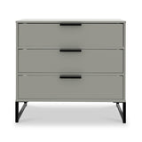 A grey three-drawer dresser with black horizontal handles and angled metal legs against a white background.