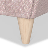 A wooden table leg extends from the bottom of a tabletop with a pink and white houndstooth pattern, against a white background.