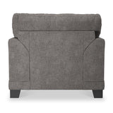 A grey fabric loveseat is centered against a white background, featuring a cushioned back, padded arms, and dark wooden legs.