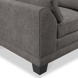 A section of a grey fabric sofa with a cushion and a visible armrest, set against a plain, light background.