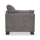 A grey upholstered armchair with cushions against an isolated white background, no discernible action or context.