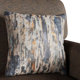 A patterned cushion with vertical streaks of blue, white, and orange rests against the back of a textured brown armchair.