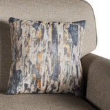 A patterned pillow rests against the backrest of a tan upholstered chair, offering a sense of home decor comfort. There is no text in the image.