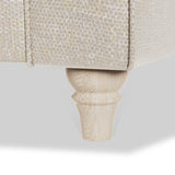 A textured sofa leg supports a section of a couch against a white background.