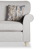 A grey upholstered sofa with wooden legs features one textured decorative pillow, set against a plain white background.