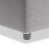 A gray upholstered couch corner with a single black cylindrical leg on a white background.