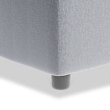 A light gray upholstered couch corner with a single visible black leg on a white background.