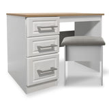 A white desk with a wooden top, three drawers on one side, and a grey cushioned chair, set against a plain background.