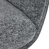 A close-up view of a heathered gray fabric covering a curved piece of furniture, likely a sofa or chair cushion, with a texture visible.