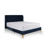 A navy blue upholstered bed with a white mattress rests stationary against a white background. The headboard has vertical tufting, and the legs are golden-hued.