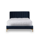 A navy blue bed with a tall, vertical panel headboard and a plush white mattress, against a white background.