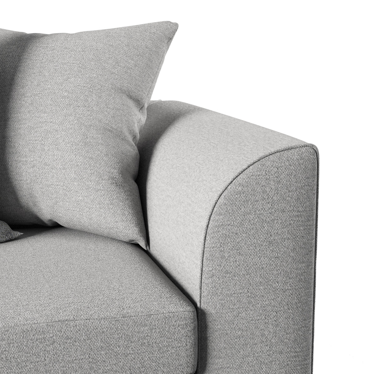 A grey fabric sofa corner showing a cushion atop an armrest, set against a white background. No text is present.