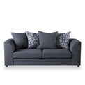 A dark grey sofa with three cushions, two featuring a pattern, sits against a pure white background.