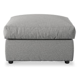 A grey fabric ottoman with a cushioned top and short black legs, isolated on a white background.