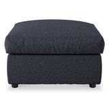 A dark upholstered ottoman with a cushioned top and short black legs, isolated on a white background.