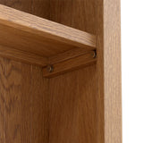 A wooden shelf corner, attached to a vertical surface with screws, against a wooden background.