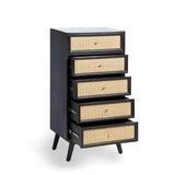 A black five-drawer dresser with rattan inlay stands against a white background. Each drawer has a round, golden knob and the unit rests on angled legs.